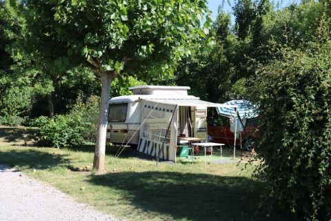 Small caravan on semi-shaded pitch